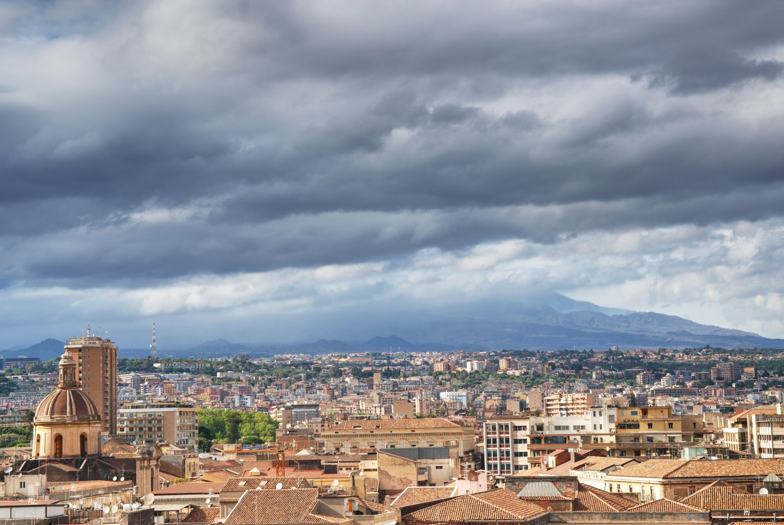 Anastasiya Dalenka · Unsplash License · https://unsplash.com/photos/a-view-of-a-city-with-mountains-in-the-background-AEUHFOsdvR4